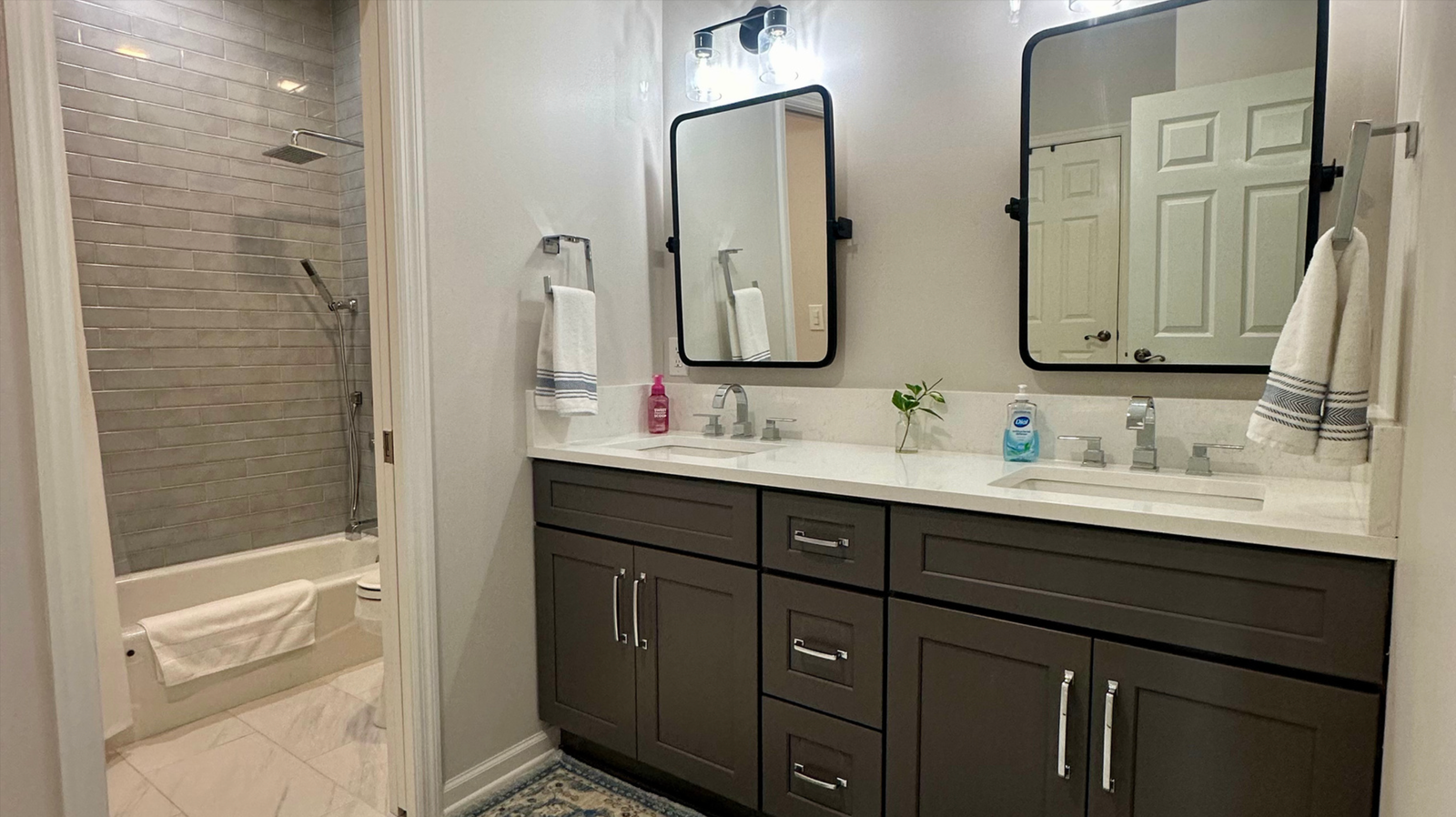 Modern bathroom with dual sinks.