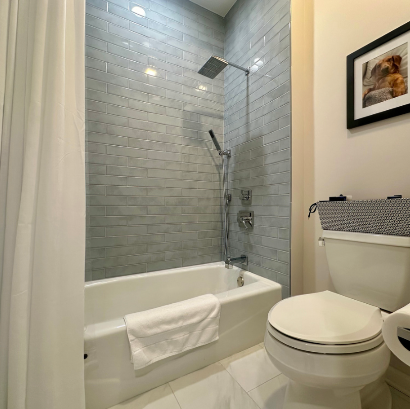 Modern bathroom with tiled shower and tub.