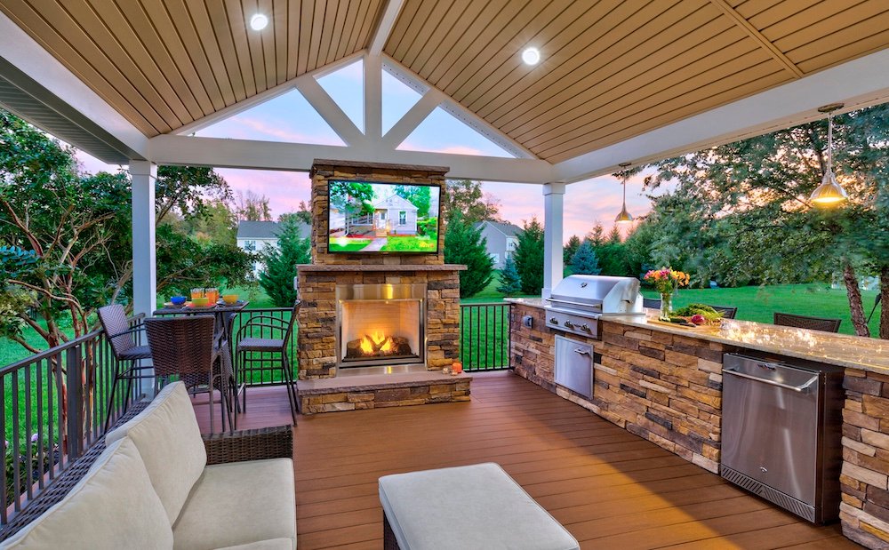 Outdoor kitchen with grill and fireplace.