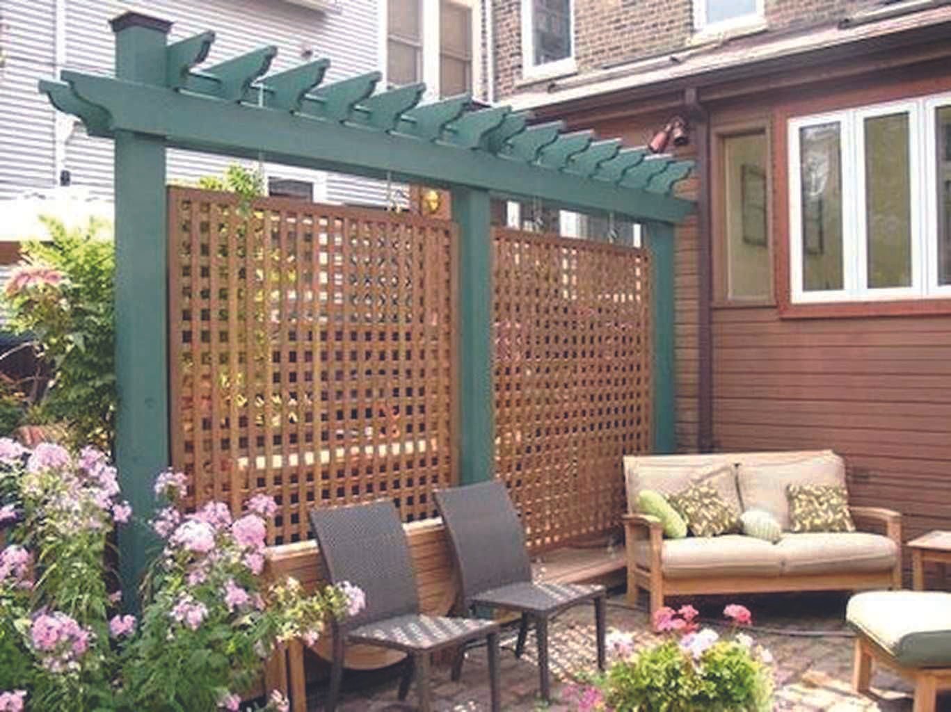 Cozy garden patio with trellis and seating.