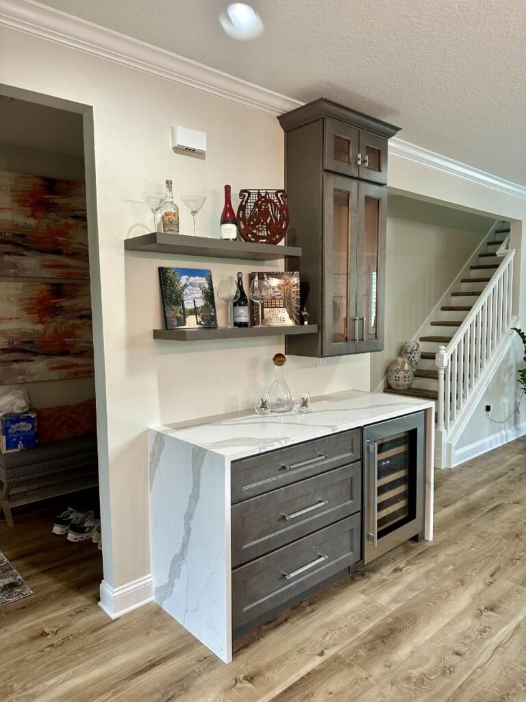 Modern home bar with shelves and wine fridge.