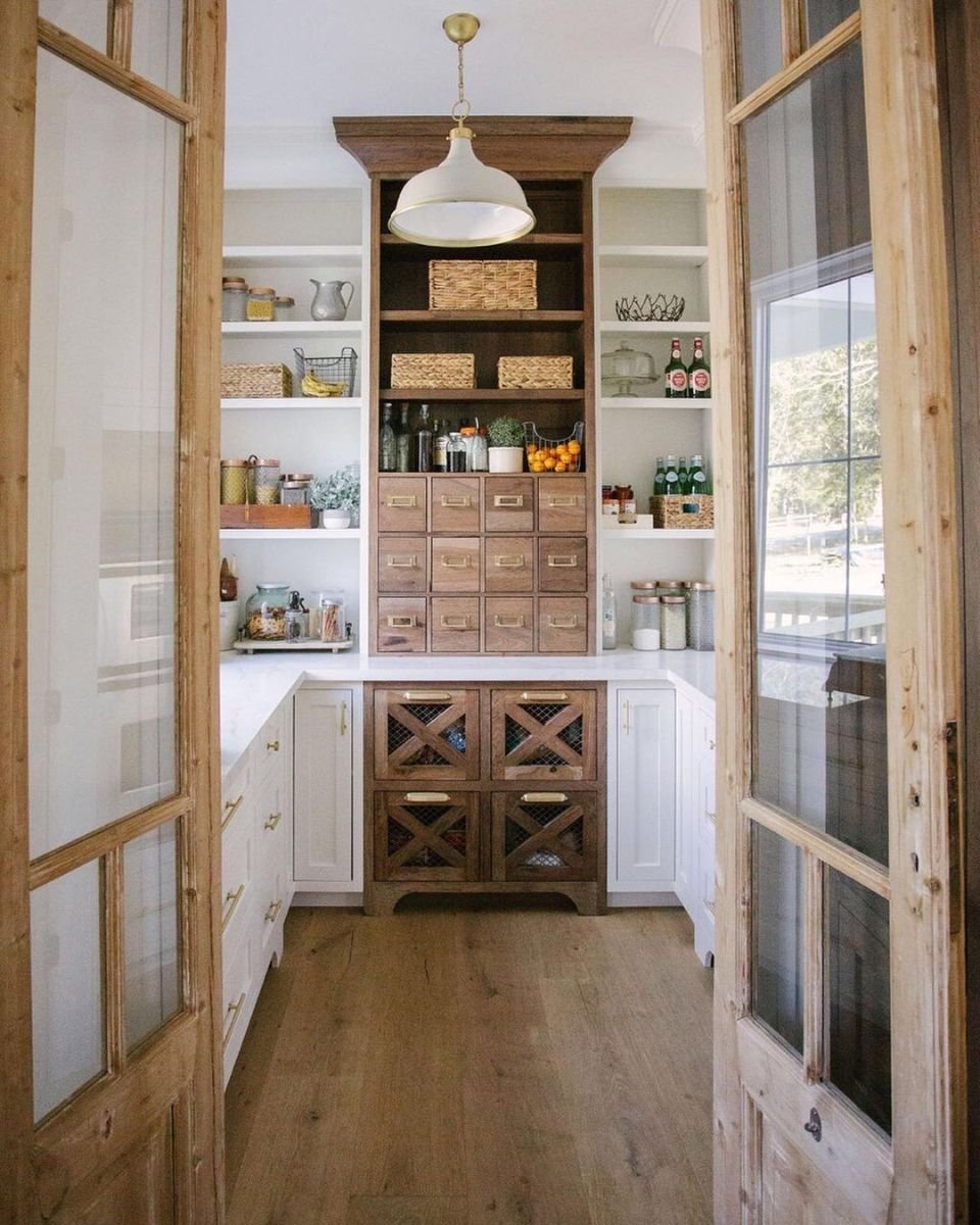 Stylish pantry with wooden shelves and drawers