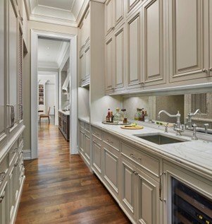 Elegant narrow kitchen with wooden floors.