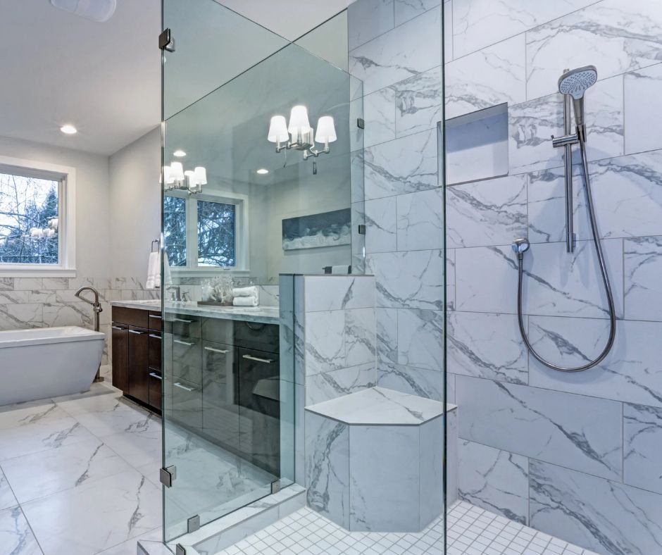 Modern marble bathroom with glass shower.