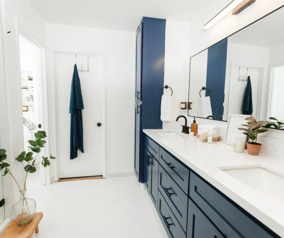 Modern bathroom with blue cabinets.